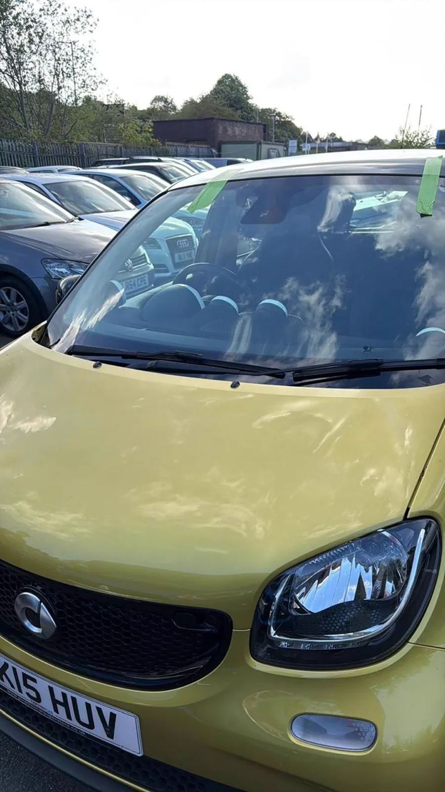 Completed windscreen work on a green Smart car